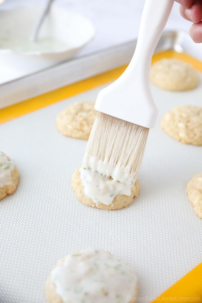 Brushing glaze on warm key lime cookies.