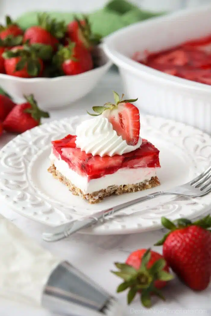 Strawberry Pretzel Salad - A layered dessert with a pretzel crust, cream cheese filling, and topped with fresh strawberries inside jello.