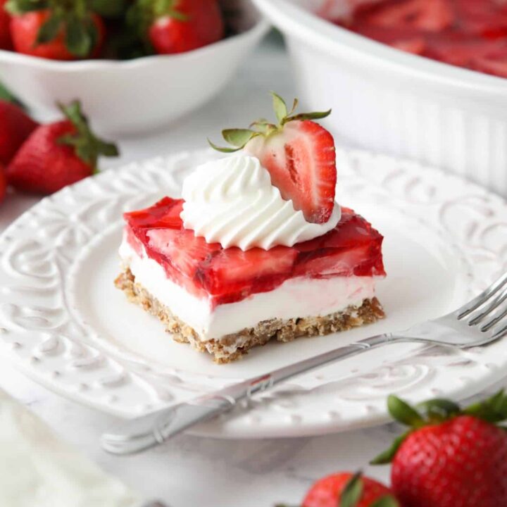 Strawberry Pretzel Salad - A layered dessert with a pretzel crust, cream cheese filling, and topped with fresh strawberries inside jello.