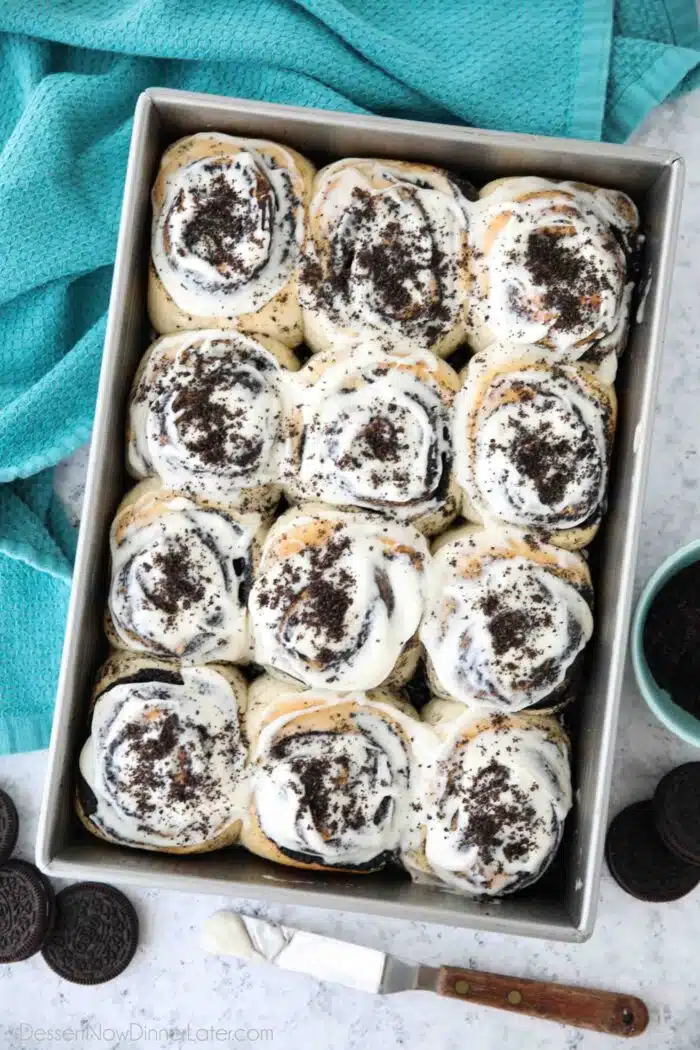 Pan of frosted Oreo cinnamon rolls with cream cheese frosting.