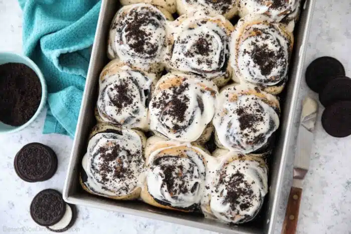 Pan of frosted Oreo cinnamon rolls with cream cheese frosting.