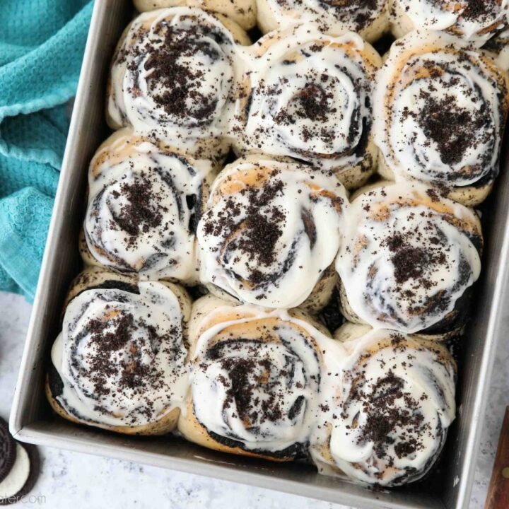Pan of frosted Oreo cinnamon rolls with cream cheese frosting.