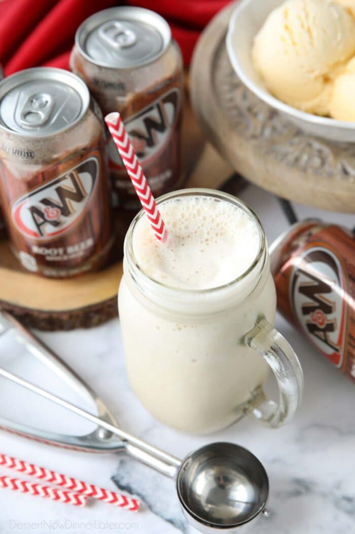 Mason jar mug full of root beer milkshake and a straw.