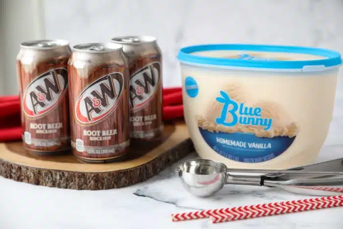 Cans of A&W Root Beer and a tub of Vanilla Ice Cream.