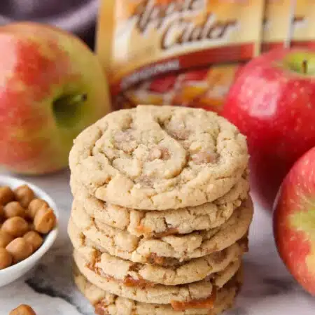 Stack of caramel apple cider cookies made with apple cider mix and caramel bits.