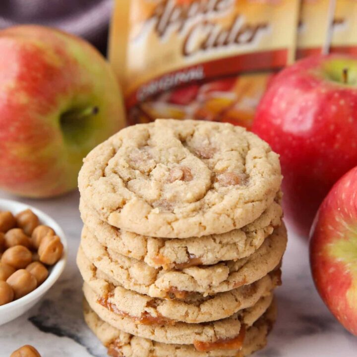 Stack of caramel apple cider cookies made with apple cider mix and caramel bits.