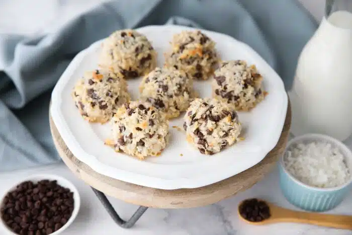 Coconut macaroons made with condensed milk and mini chocolate chips on a plate.