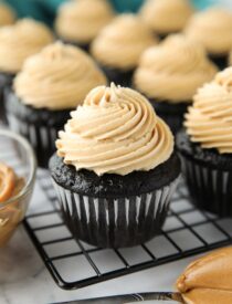 Peanut butter frosting piped on top of a chocolate cupcake.