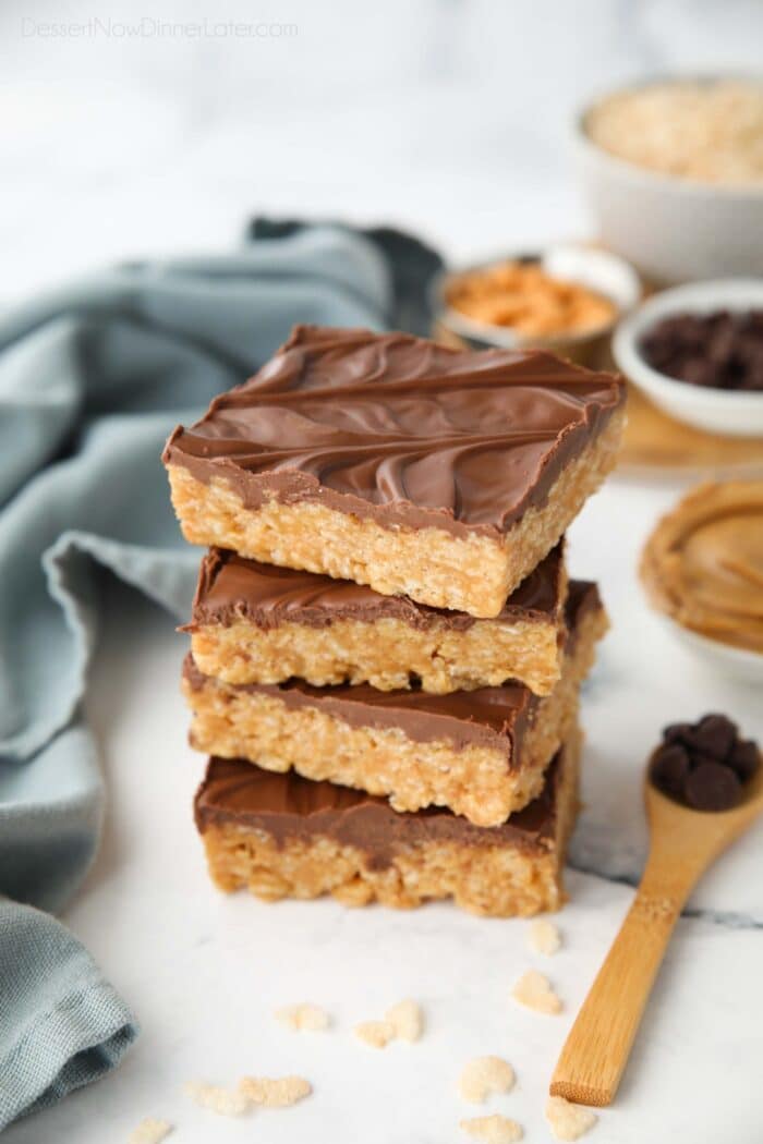 Stack of scotcharoos -- chocolate covered rice krispie treats with peanut butter and butterscotch.