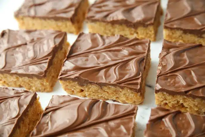 Chocolate covered rice krispie treats with peanut butter and butterscotch.