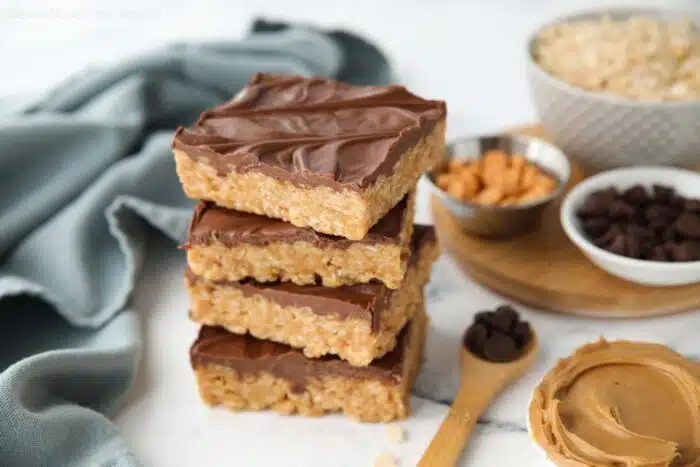 Stack of scotcharoos -- chocolate covered rice krispie treats with peanut butter and butterscotch.