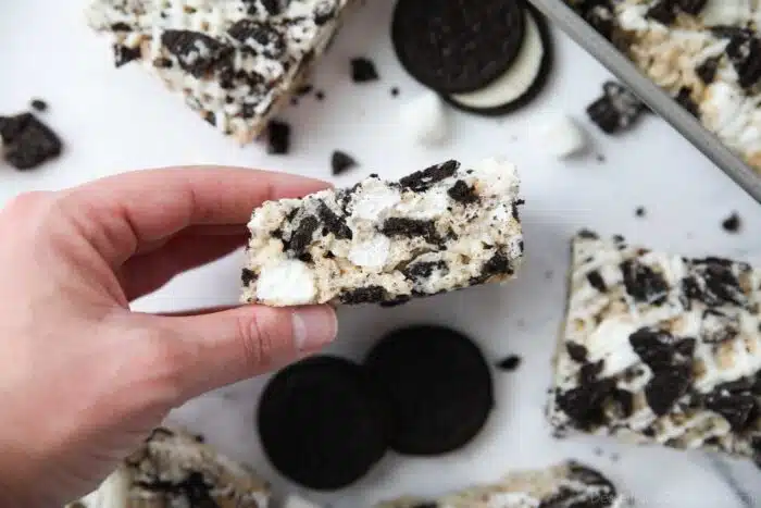 Holding a rice krispie treat with Oreos.