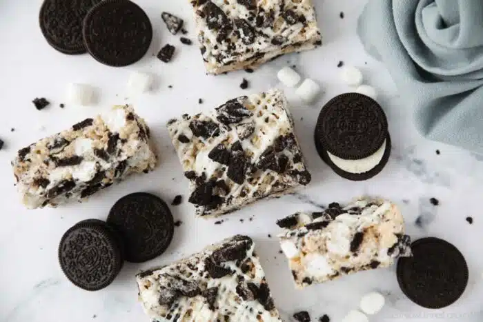 Rice krispie treats with white chocolate drizzle and Oreo chunks.