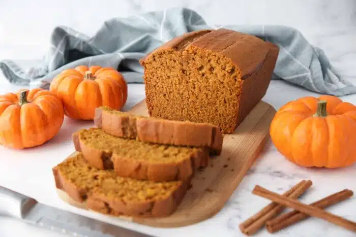 Better than Starbucks pumpkin loaf on a cutting board with a few slices cut off.
