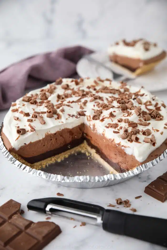 Chocolate Truffle Pie in pan with pieces taken out to show filling.