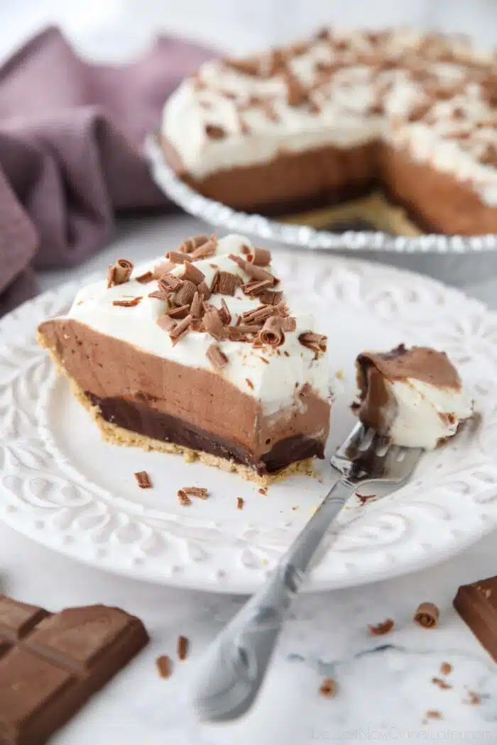 Slice of Chocolate Truffle Pie on a plate with a fork-full removed.