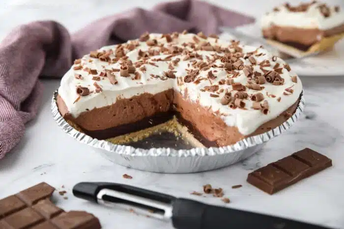 Chocolate Truffle Pie in pan with pieces taken out to show filling.