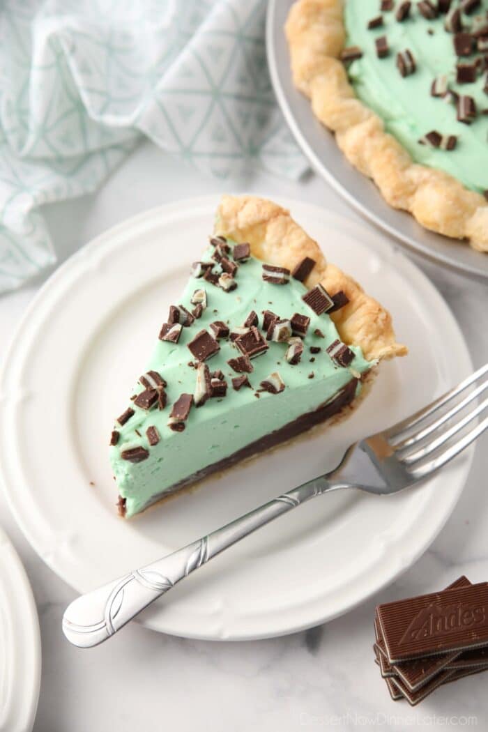 Slice of chocolate mint pie on a plate with a fork.