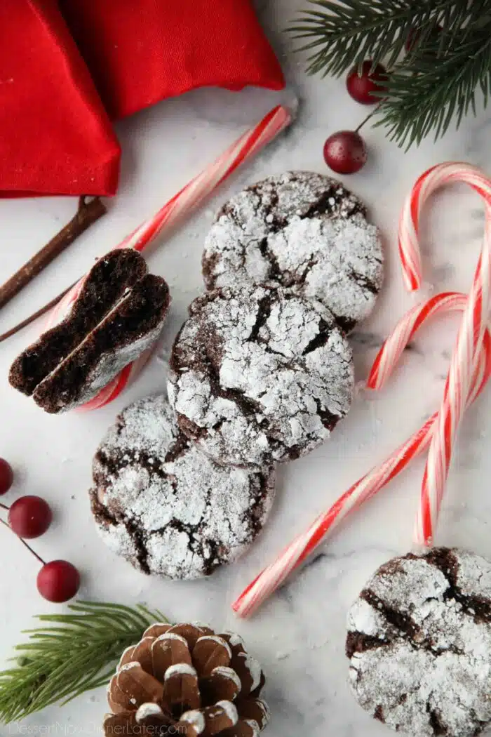 Close up of chocolate crinkle cookies with peppermint candy canes.