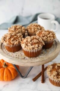 Pumpkin streusel muffins on a cake stand.