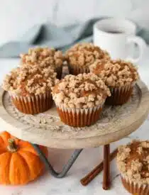 Pumpkin streusel muffins on a cake stand.