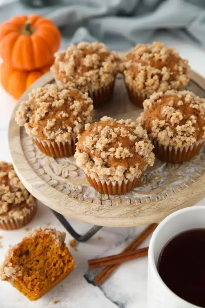 Pumpkin streusel muffins with crumb topping on a cake stand.