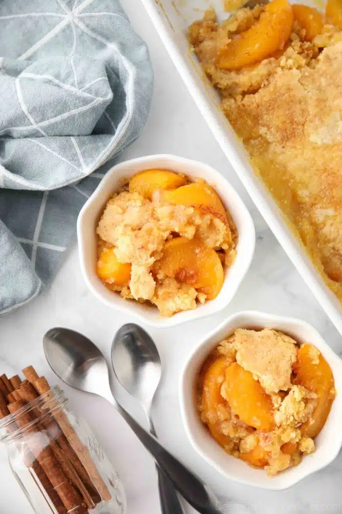 Top view of bowls full of peach dump cake (aka peach cobbler with cake mix).