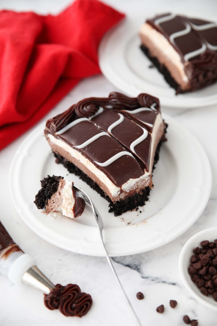 Piece of homemade Olive Garden Black Tie Mousse Cake on a plate with a forkful taken out.