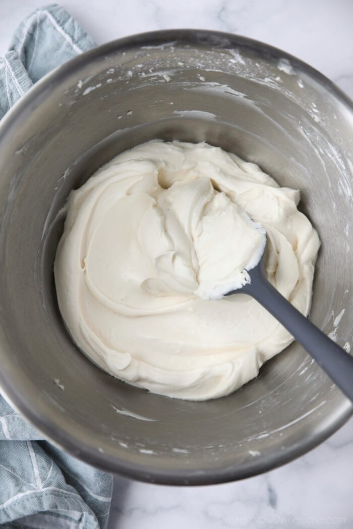 The best cream cheese frosting in a bowl with a spatula.