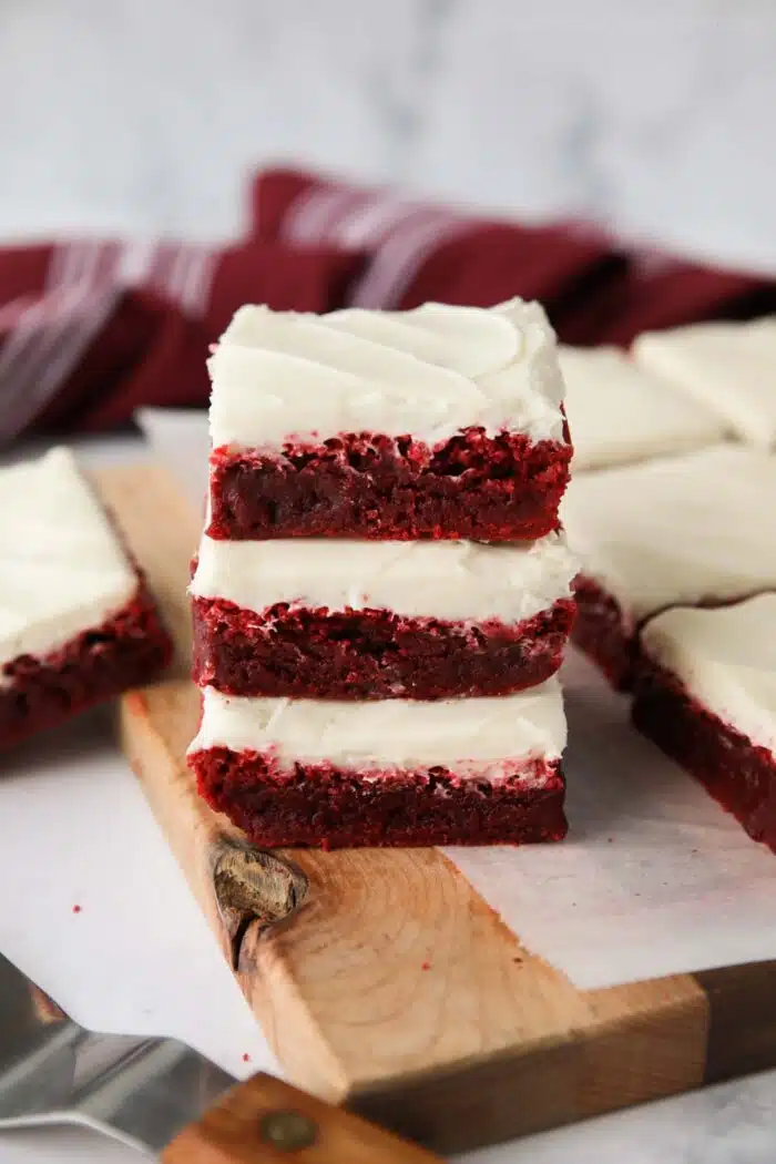 Stack of three Red Velvet Brownies with cream cheese frosting.