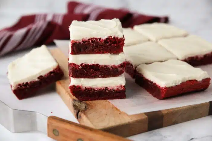 Stack of three Red Velvet Brownies with cream cheese frosting.