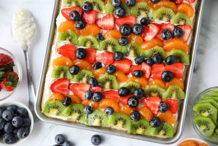 Top view of sugar cookie fruit pizza bars with cream cheese frosting.
