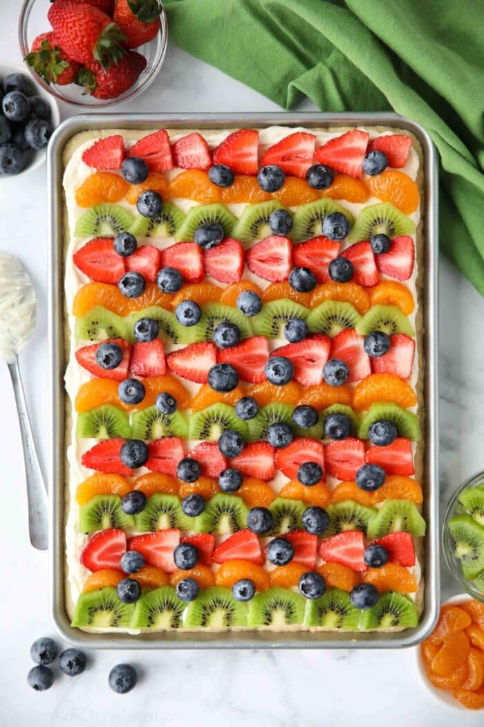 9x13 sugar cookie fruit pizza topped with different fruits.