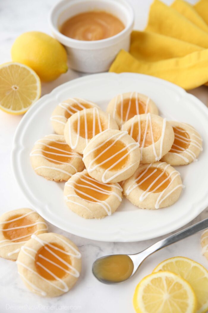 Plate of lemon curd cookies with glaze drizzled on top.