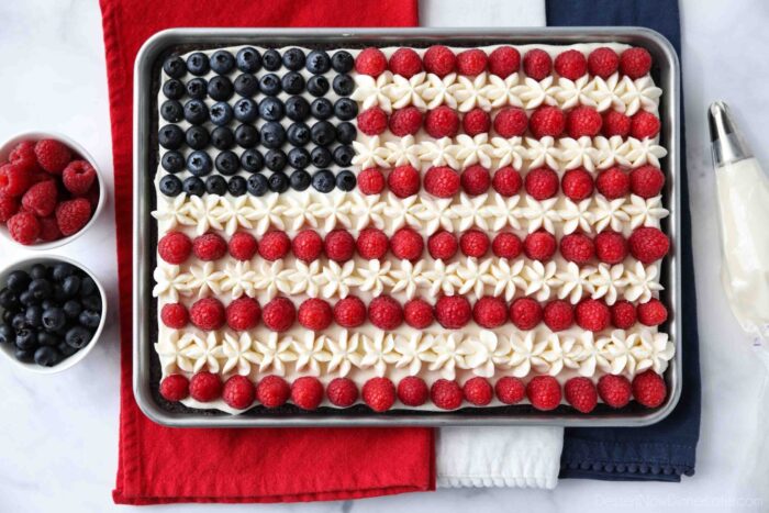 4th of July Fruit Pizza made with a brownie base and decorated with whipped cream cheese frosting, blueberries and raspberries for the stars and stripes.