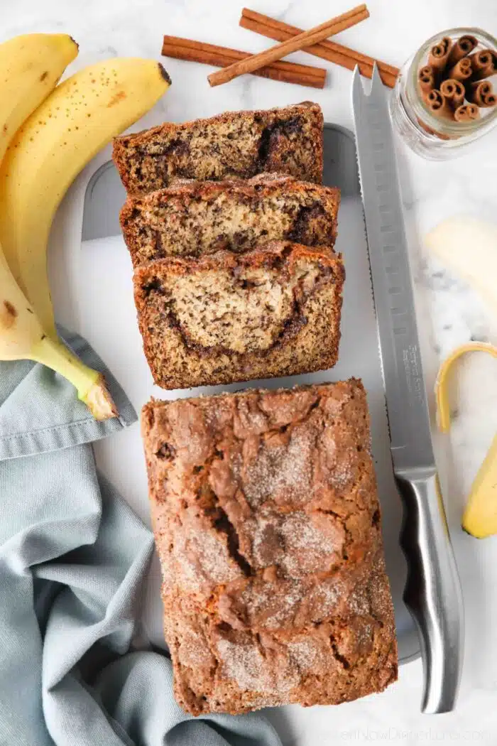 Loaf of cinnamon swirl banana bread with a few slices cut off the end.