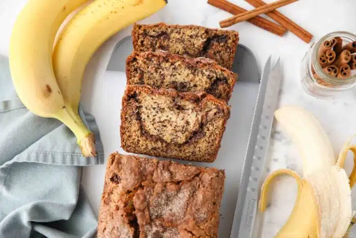 Loaf of cinnamon swirl banana bread with a few slices cut off the end.