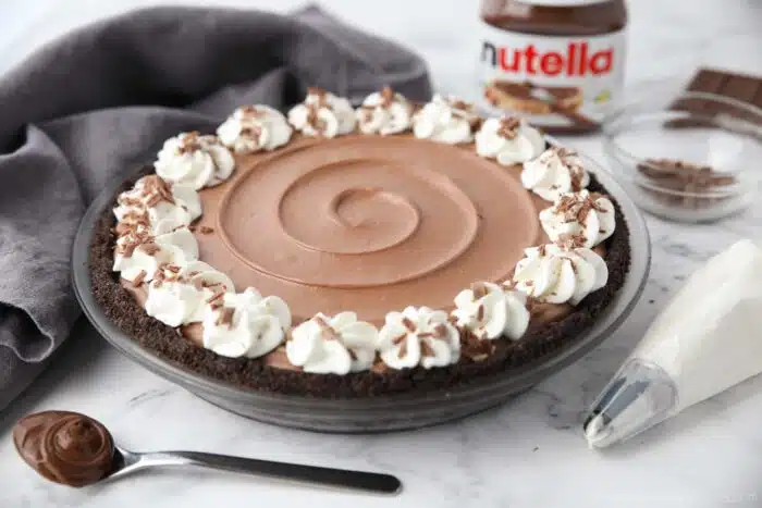 Side view of no bake Nutella cheesecake made in a pie pan.