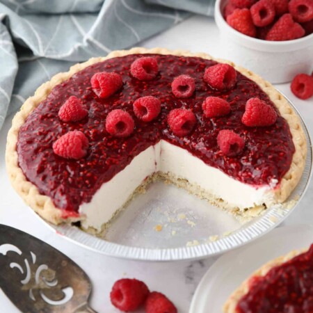 Slices removed from pie pan to show the inside of Raspberry Cream Cheese Pie.