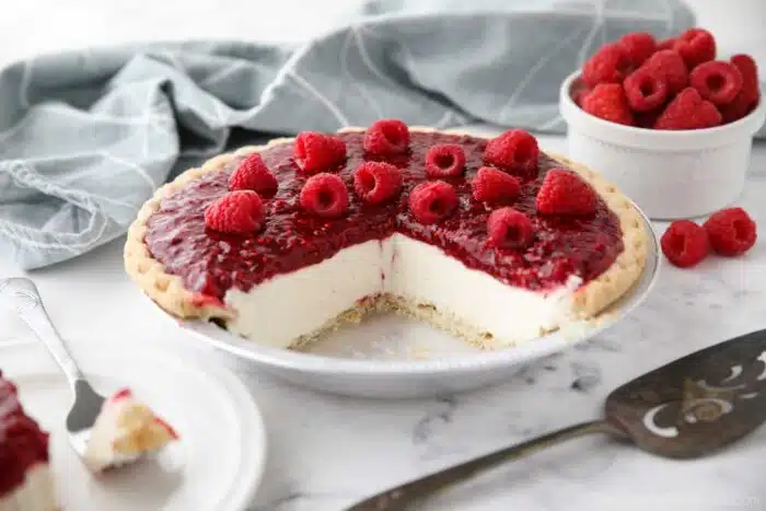 Slices removed from pie pan to show the inside of Raspberry Cream Pie.