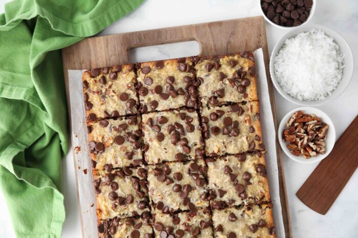 Top view of German Chocolate Bars cut into squares on a wooden cutting board.