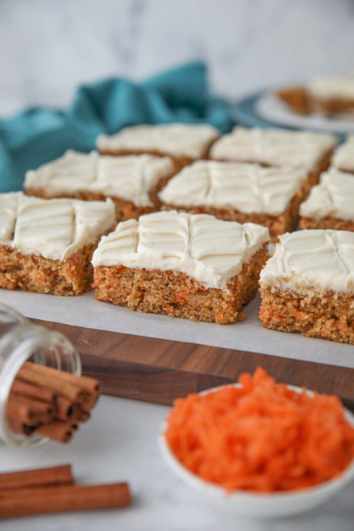 Side view of squares of carrot bars with maple frosting.