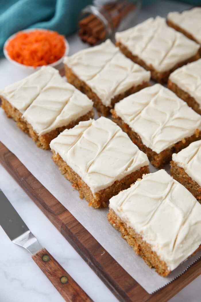 Top view of squares of carrot bars with frosting.