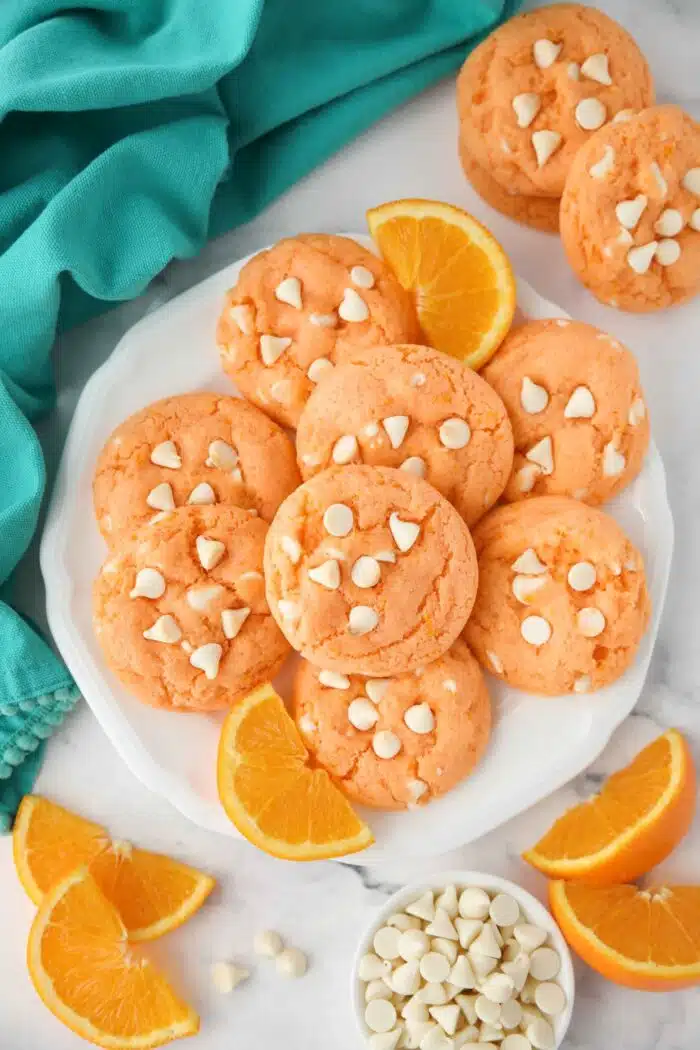 Plate of orange creamsicle cookies with white chocolate chips.