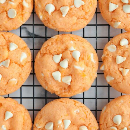 Orange creamsicle cookies cooling on a wire rack.