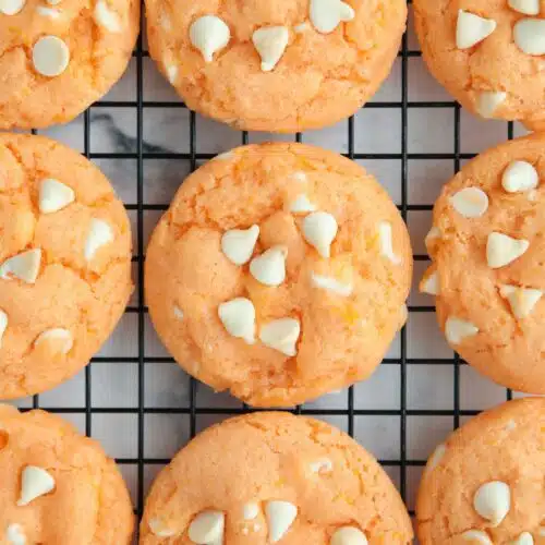Orange creamsicle cookies cooling on a wire rack.