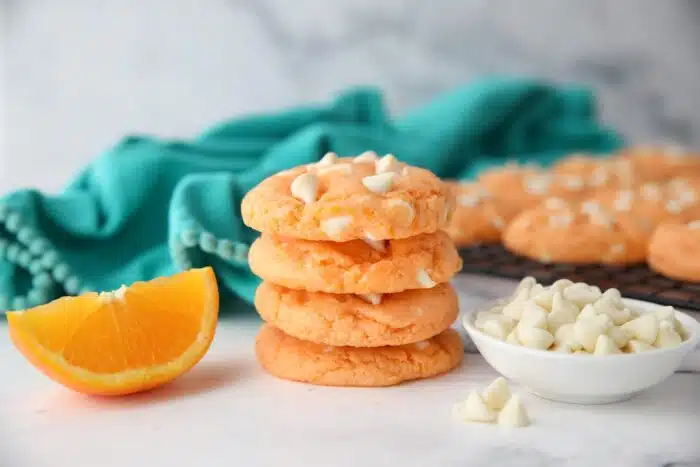 Stack of creamsicle orange cookies with white chocolate chips.