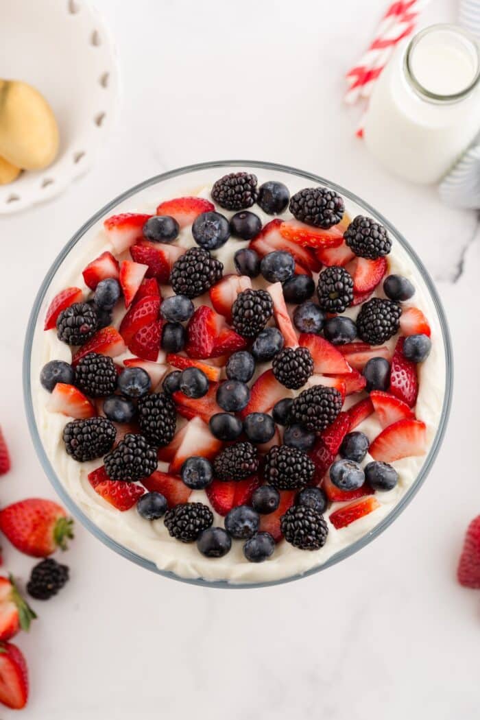 Topping 4th of July trifle with red and blue berries.