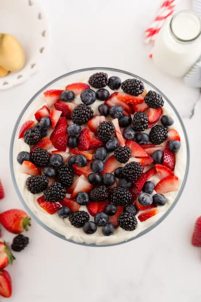 Topping 4th of July trifle with red and blue berries.