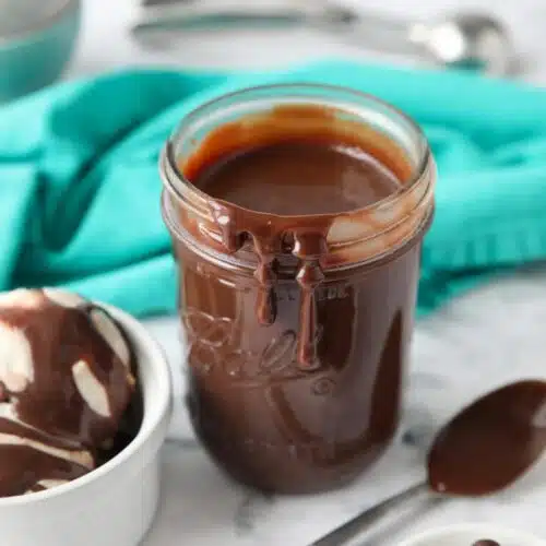 Hot fudge dripping down the side of a mason jar.